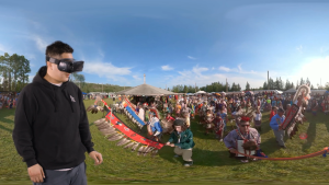 Overlay of youth using a VR headset over photo of Powwow